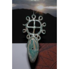 Cross inside a solar disc on top of an eye-like symbol